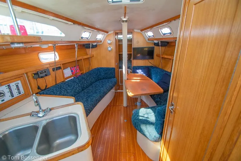 Slide: The Image of Interior of 1997 Catalina 320 MkII sailboat with cozy seating and wooden finishes. - 7