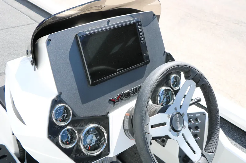 Slide: The Image of 2025 Vexus AVX 2080 boat dashboard with steering wheel and digital display. - 17
