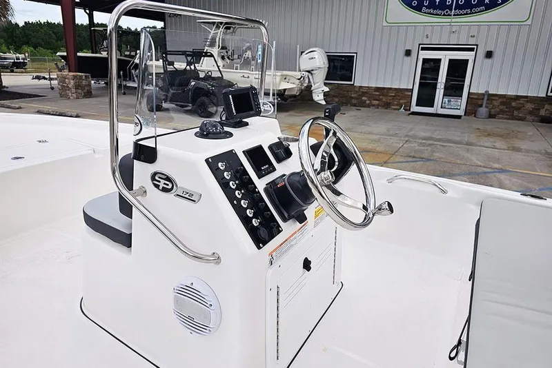 Slide: The Image of 2026 Sea Pro 172 Bay boat console with steering wheel and controls, parked outdoors. - 11