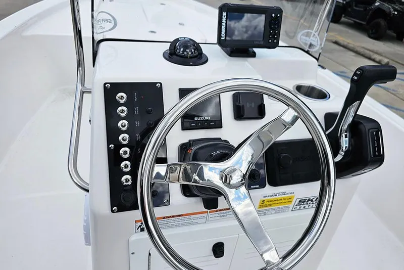 Slide: The Image of 2026 Sea Pro 172 Bay boat dashboard with steering wheel and control panel. - 13