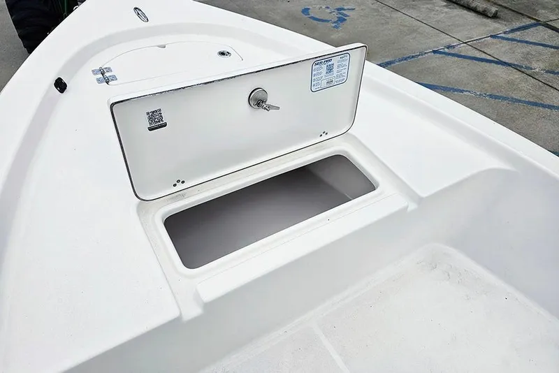Slide: The Image of 2026 Sea Pro 172 Bay boat storage compartment with open hatch and key lock. - 16