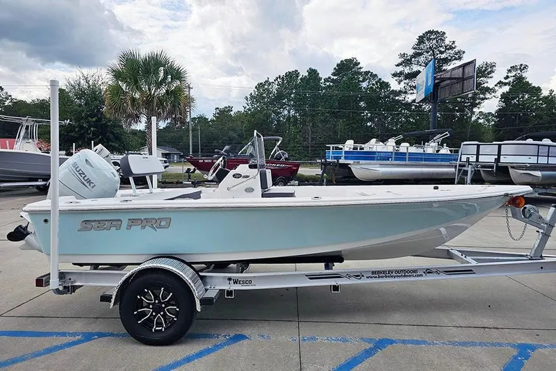 Slide: The Image of 2026 Sea Pro 172 Bay boat on trailer, parked outdoors with trees in background. - 6