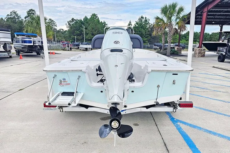 Slide: The Image of 2026 Sea Pro 172 Bay boat with outboard motor, parked in a marina. - 8