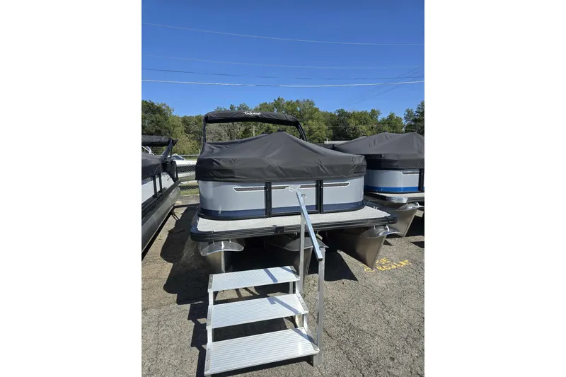 Slide: The Image of 2026 Qwest RLS E-Class pontoon boat with cover and boarding steps. - 12