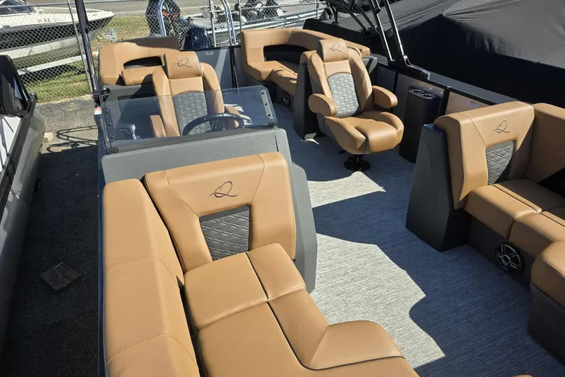 Slide: The Image of Luxurious interior of 2026 Qwest RLS E-Class boat with tan and black seating. - 5