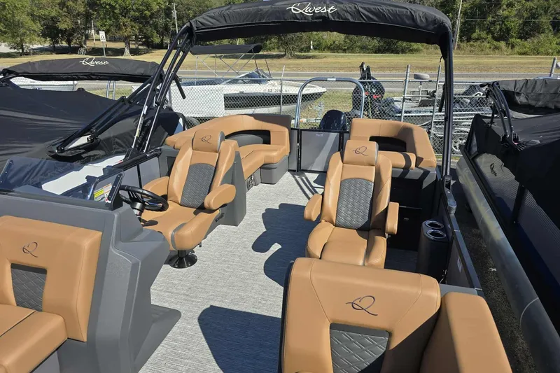 Slide: The Image of 2026 Qwest RLS E-Class boat interior with tan and black seating, sleek design. - 6