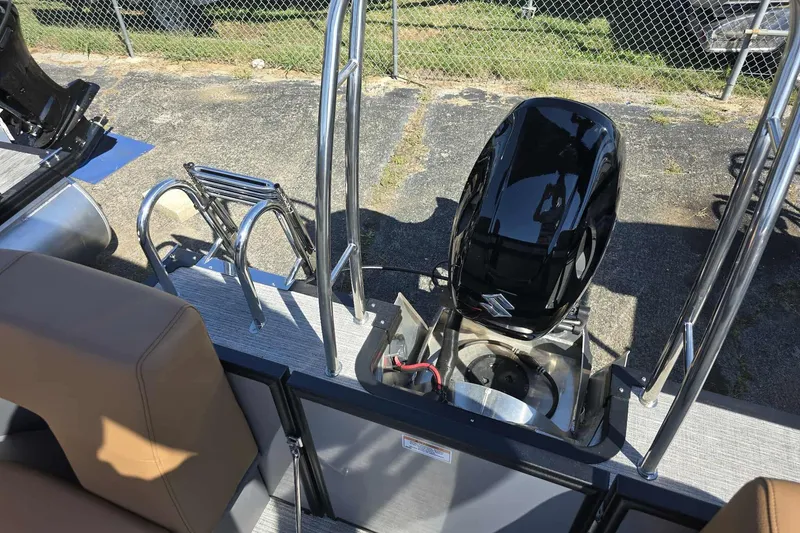 Slide: The Image of Rear view of 2026 Qwest RLS E-Class boat with Suzuki outboard motor and ladder. - 9