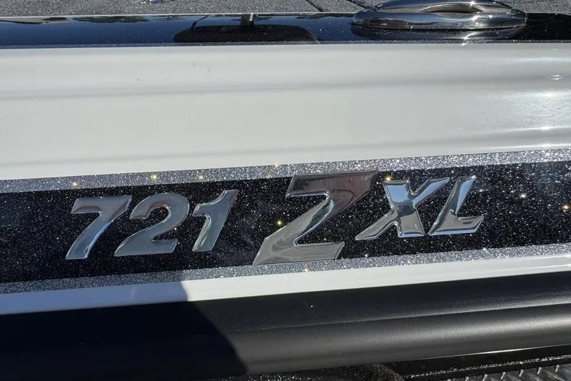 Slide: The Image of 2026 Phoenix 721 ZXL boat emblem with metallic finish and sleek design. - 2