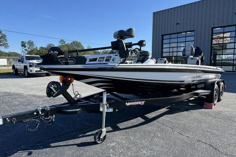 Slide: The Image of 2026 Phoenix 721 ZXL boat on trailer, parked outside a building on a sunny day. - 3