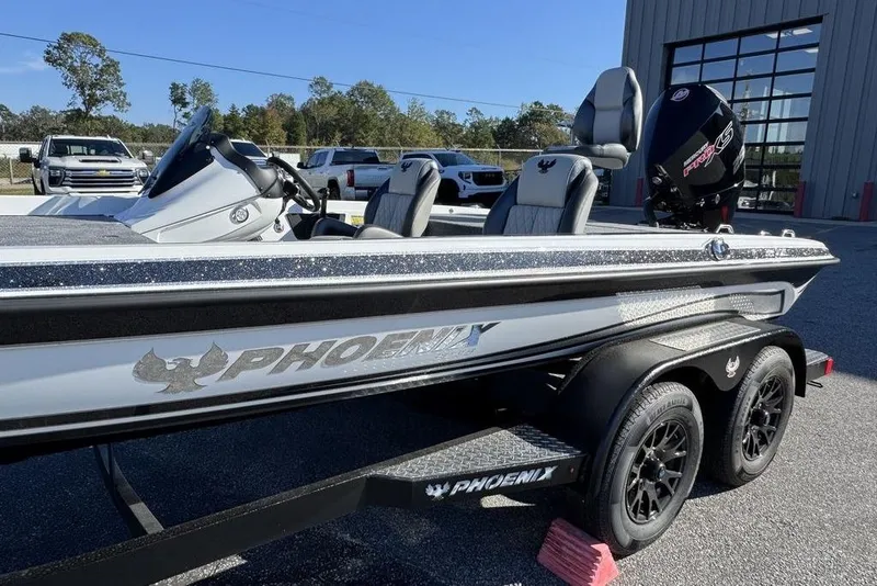 Slide: The Image of 2026 Phoenix 721 ZXL boat on trailer, parked outdoors near a building. - 4
