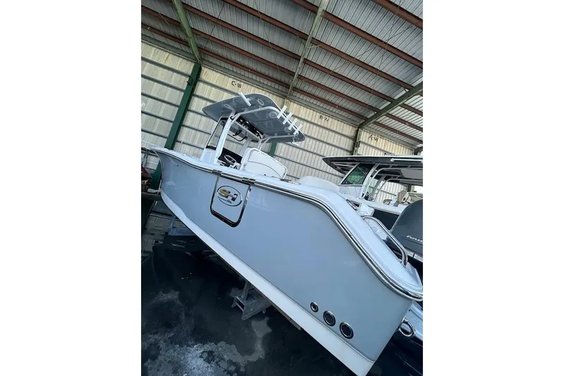The Image of 2023 Seahunt SXS boat in storage, featuring sleek design and modern features. - 1
