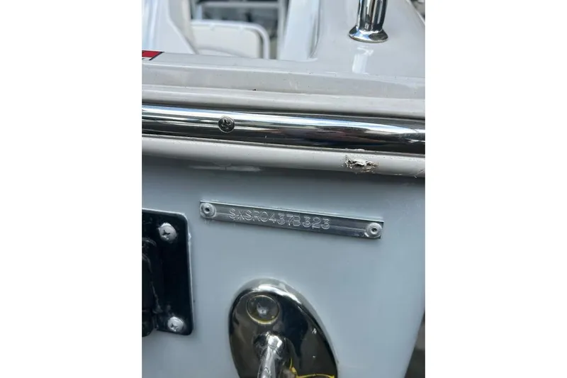 Slide: The Image of 2023 Seahunt SXS boat with visible serial number plate and chrome details. - 12