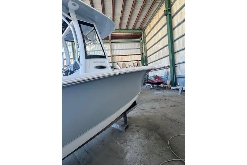 Slide: The Image of 2023 Sea Hunt Ultra 265 SE boat in a storage facility. - 16