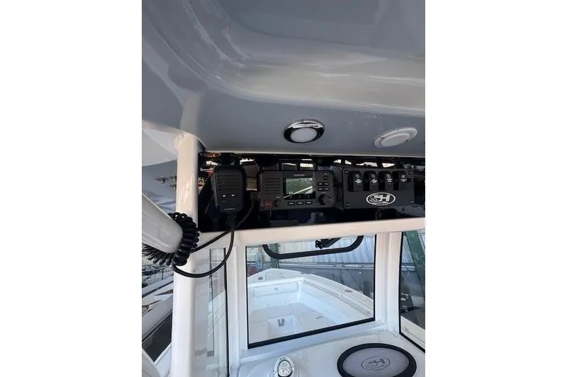 Slide: The Image of 2023 Sea Hunt Ultra 265 SE boat console with electronic controls and navigation equipment. - 18