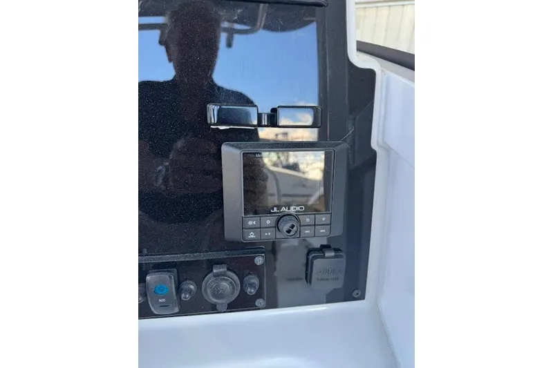 Slide: The Image of 2023 Sea Hunt Ultra 265 SE dashboard with JL Audio system. - 19