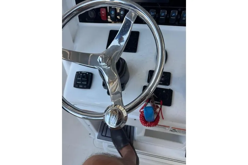 Slide: The Image of Steering wheel of 2023 Sea Hunt Ultra 265 SE boat with control panel. - 20
