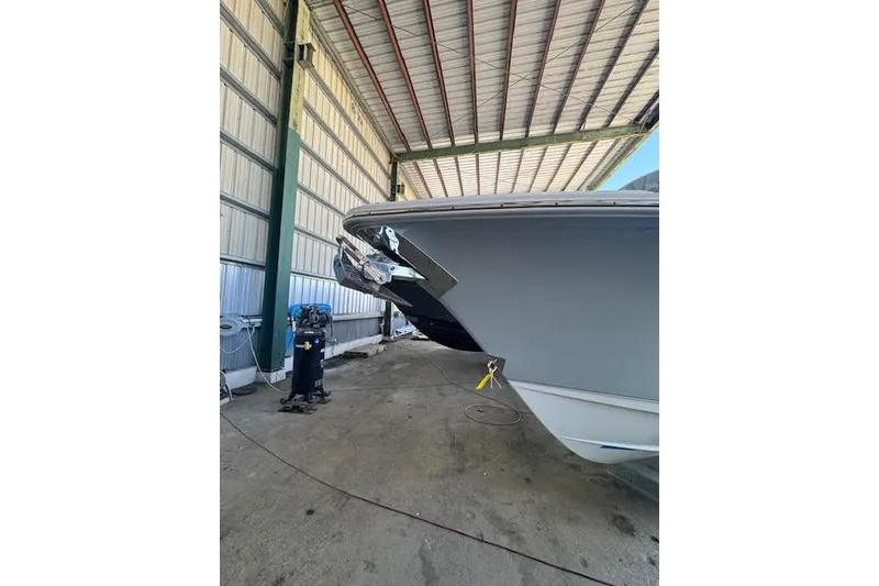Slide: The Image of 2023 Sea Hunt Ultra 265 SE boat in covered storage facility. - 23