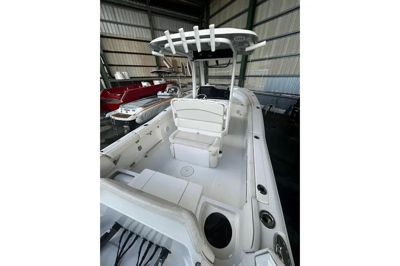 Slide: The Image of 2023 Seahunt SXS boat interior with seating and storage, displayed in a showroom. - 5