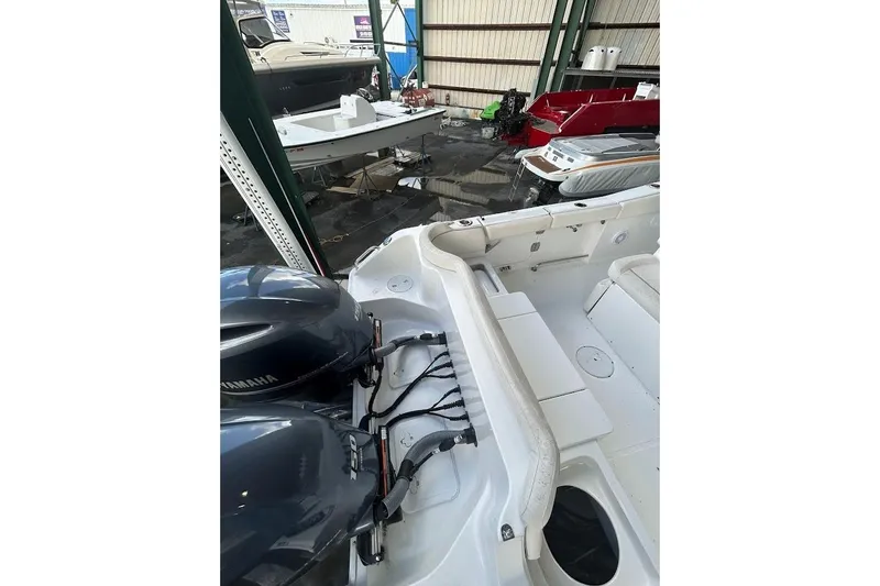 Slide: The Image of 2023 Seahunt SXS boat with dual Yamaha engines in a storage facility. - 6