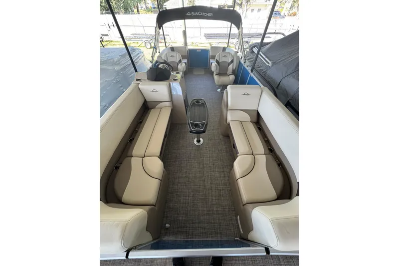 Slide: The Image of 2026 SunCatcher Select 22RC pontoon boat interior with beige seating and modern design. - 1