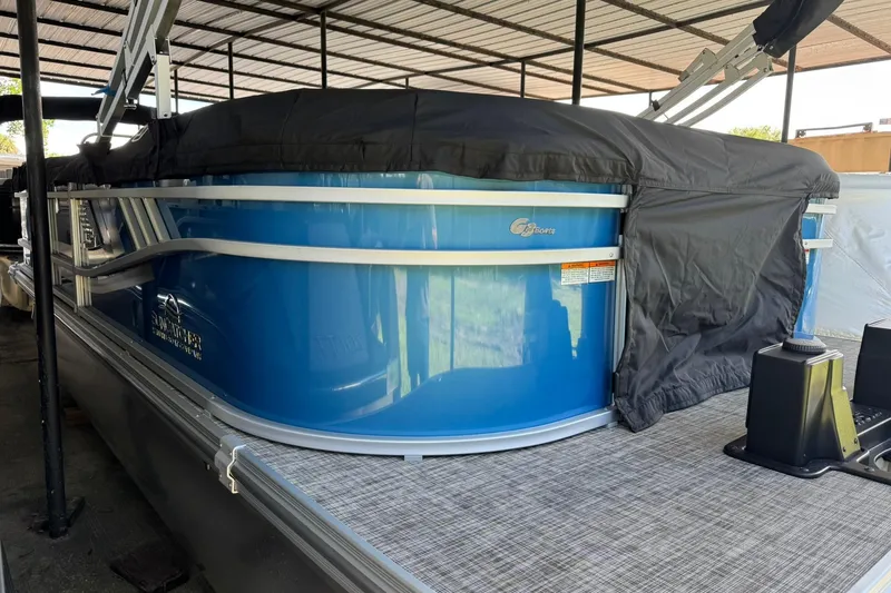 Slide: The Image of 2026 SunCatcher Select 22RC pontoon boat with blue exterior under cover. - 4