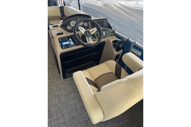 Slide: The Image of 2026 SunCatcher Select 22RC boat interior with steering wheel and beige seating. - 6