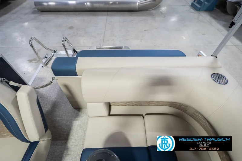 Slide: The Image of 2026 Bennington 168 SLJ boat interior with beige and blue seating, showroom display. - 18