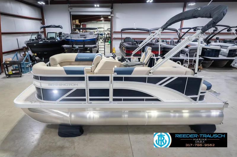 The Image of 2026 Bennington 168 SLJ pontoon boat in showroom, featuring sleek design and comfortable seating. - 2