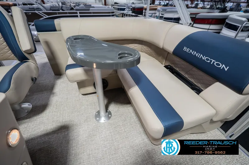 Slide: The Image of 2026 Bennington 168 SLJ boat interior with blue and beige seating and table. - 23