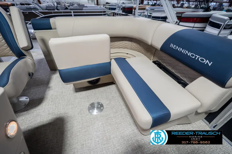 Slide: The Image of 2026 Bennington 168 SLJ boat interior with blue and beige seating, Reeder-Trausch Marine logo. - 26