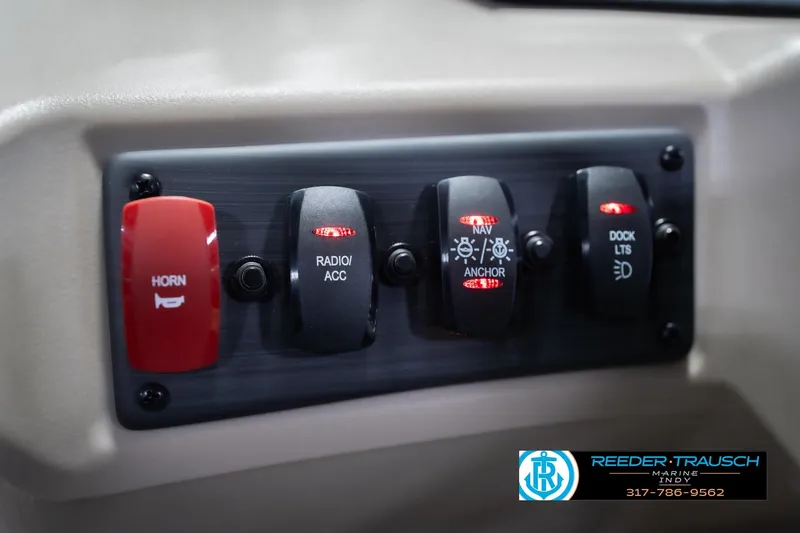 Slide: The Image of Control panel of 2026 Bennington 168 SLJ boat with labeled switches for horn, radio, navigation, and dock lights. - 32