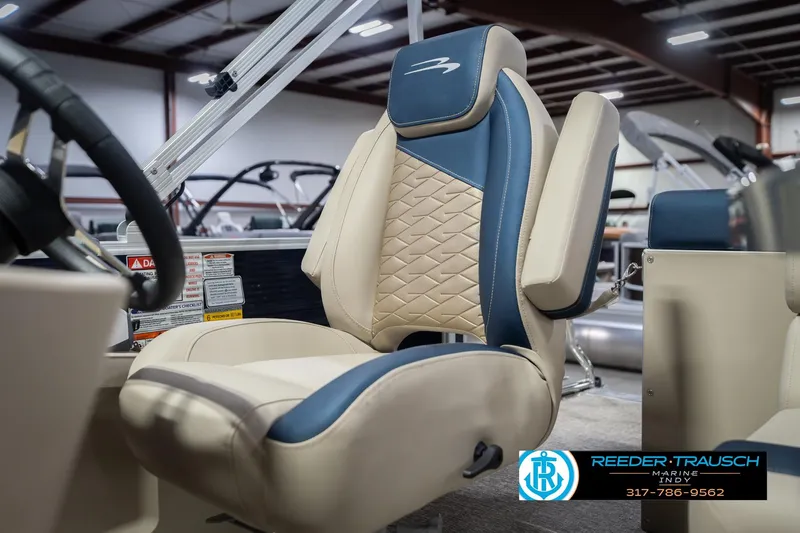 Slide: The Image of 2026 Bennington 168 SLJ boat seat with blue and beige upholstery in showroom. - 38