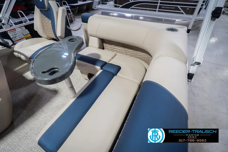 Slide: The Image of 2026 Bennington 168 SLJ boat interior with beige and blue seating, featuring a sleek table. - 40