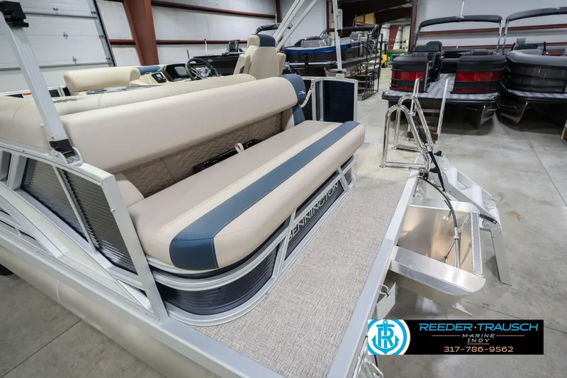 Slide: The Image of 2026 Bennington 168 SLJ pontoon boat interior with beige seating in showroom. - 57