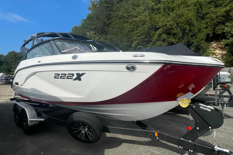 The Image of 2026 Yamaha Boats 222XD on trailer, white and red design, parked outdoors. - 0