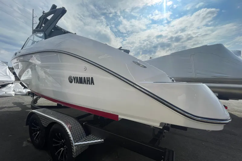 Slide: The Image of 2026 Yamaha Boats 222XD on trailer under a partly cloudy sky. - 10