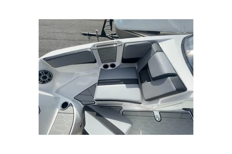 Slide: The Image of 2026 Yamaha Boats 222XD interior seating with gray upholstery and cup holders. - 21