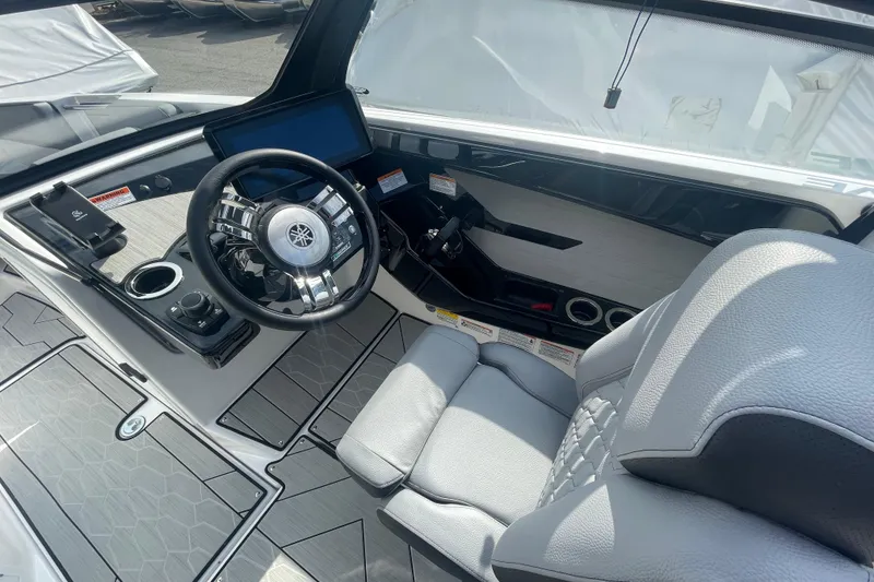 Slide: The Image of Interior view of 2026 Yamaha Boats 222XD, featuring sleek steering and modern controls. - 7