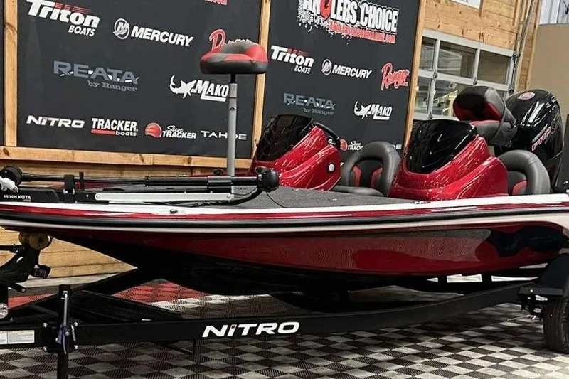 Slide: The Image of 2026 Nitro Z17 boat in showroom, red and black design, displayed on checkered floor. - 3