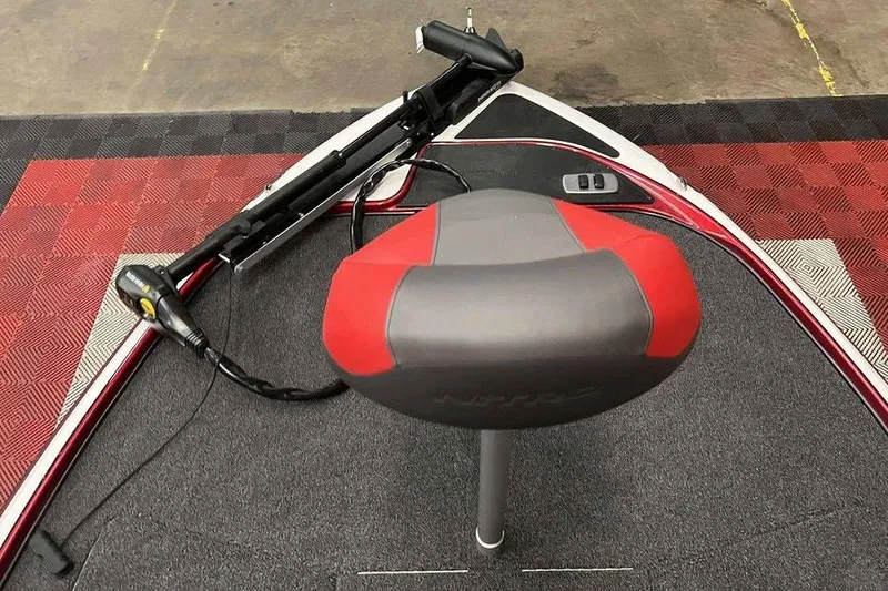 Slide: The Image of Nitro Z17 2026 boat seat and trolling motor on patterned flooring. - 7