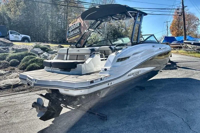Slide: The Image of 2023 Monterey M6 boat with sleek design and spacious seating, displayed outdoors. - 10