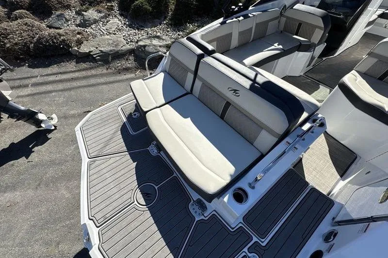 Slide: The Image of 2023 Monterey M6 boat interior with cushioned seating and sleek design. - 7