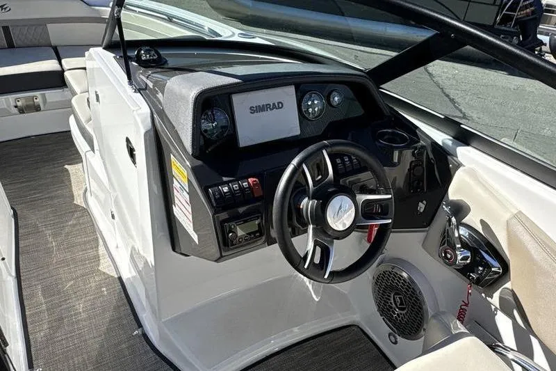 Slide: The Image of 2023 Monterey M6 boat cockpit with steering wheel, Simrad display, and control panel. - 8