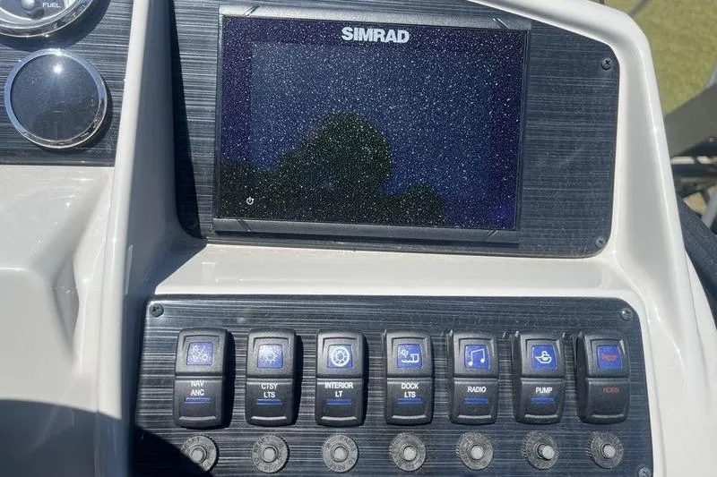 Slide: The Image of Control panel of 2025 Sylvan Mirage 820 CLZ DH with Simrad display and switches. - 11