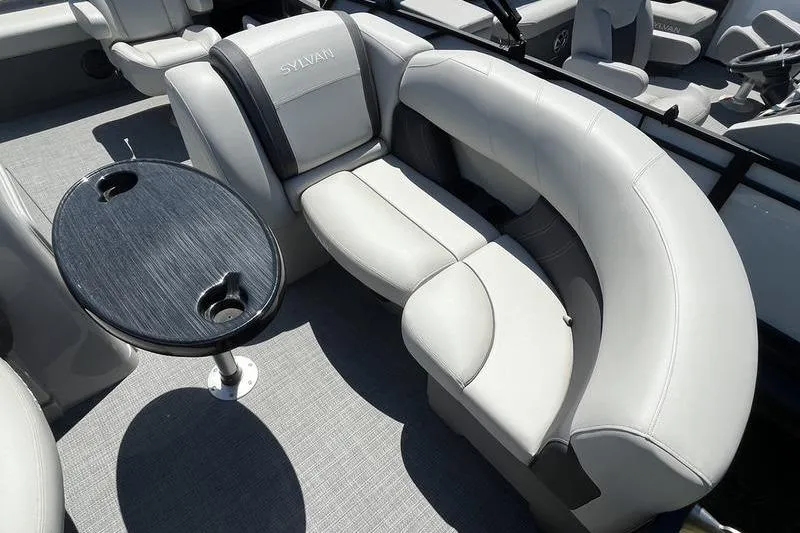 Slide: The Image of Luxurious seating on 2025 Sylvan Mirage 820 CLZ DH pontoon boat with sleek table design. - 12