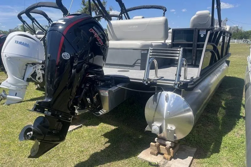 Slide: The Image of 2025 Sylvan Mirage 820 CLZ DH pontoon boat with powerful outboard motor on display. - 2