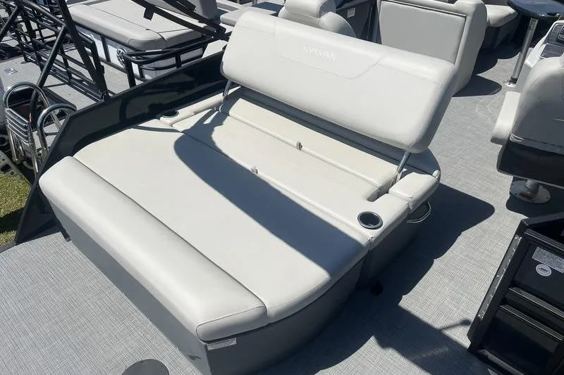 Slide: The Image of 2025 Sylvan Mirage 820 CLZ DH boat interior with comfortable seating and cup holder. - 4