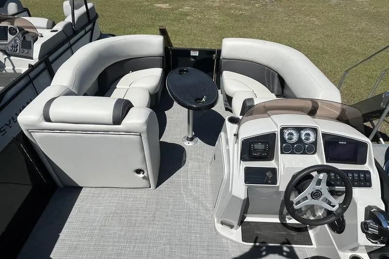 Slide: The Image of 2025 Sylvan Mirage 820 CLZ DH boat interior with helm, seating, and table. - 7