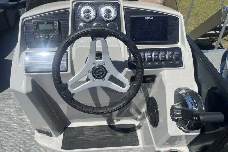 Slide: The Image of Steering console of 2025 Sylvan Mirage 820 CLZ DH with modern controls and gauges. - 9