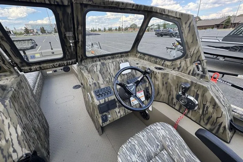 Slide: The Image of 2026 SeaArk EasyCat boat interior with camouflage seats and steering console. - 13